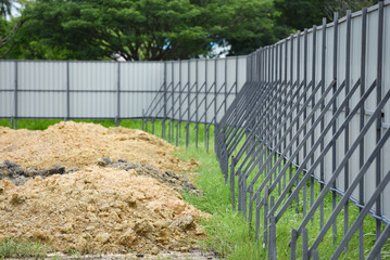 line of metal construction fence on duty on site