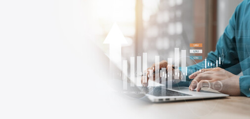 business finance and investment with a captivating data analysis concept, businessman using laptop and tablet to analyze market data, plan strategies, and conduct market research.