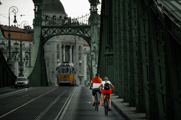 Trafic in Budapest. Cyclists on the historic bridge in Budapest.