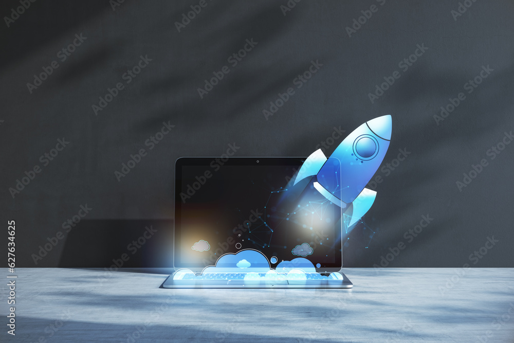 Aufkleber close up of laptop at workplace with glowing flying blue rocket on concrete wall background. start u