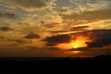 Fototapeta na wymiar Breathtaking Skies Over the Ocean at Sunset