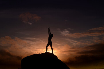 Woman Reaching Up to the Sky at Sunrise