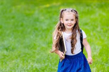Back to school and happy times.Girl with backpack and drawing board. 