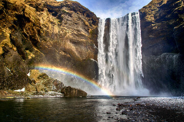 Waterfall Skogarfoss with a rainbow in the front in Iceland