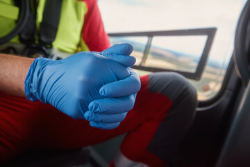 Close-up hands of doctor in surgical gloves inside helicopter of emergency medical service. Themes...