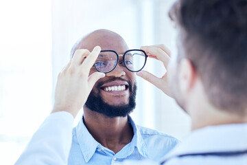 Smile, African man and optometrist with glasses for eye support and lens check at a doctor consultation. Medical, wellness and patient with vision and eyewear care with professional holding frame