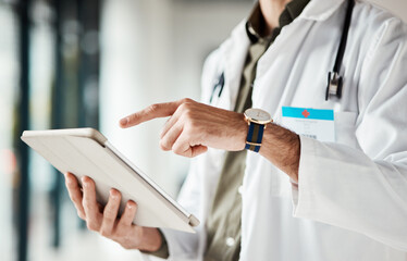 Hands, tablet and man doctor typing message, social media or planning online schedule in hospital....