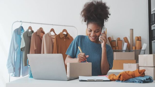 Pretty African American sme business woman working Custom Ecommerce Packaging leading supplier of custom packaging. create a personalised experience, fast production and competitive pricing