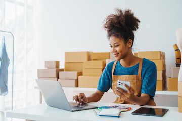 Pretty African American sme business woman working Custom Ecommerce Packaging leading supplier of...
