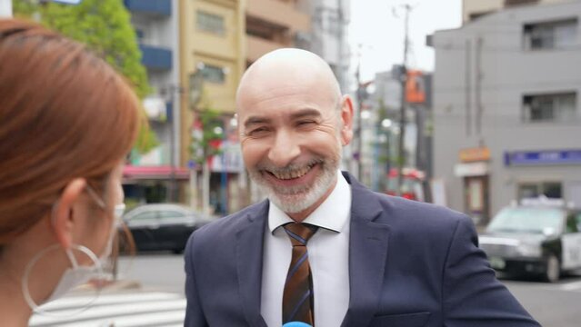 A Caucasian man interviewed on the street in a local city.