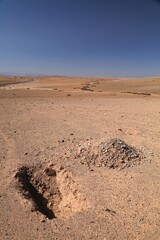 Shallow grave in the desert. Agafay desert near Marrakesh, Morocco.