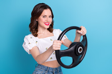 Photo of cheerful positive girl dressed white top driving auto empty space isolated blue color background