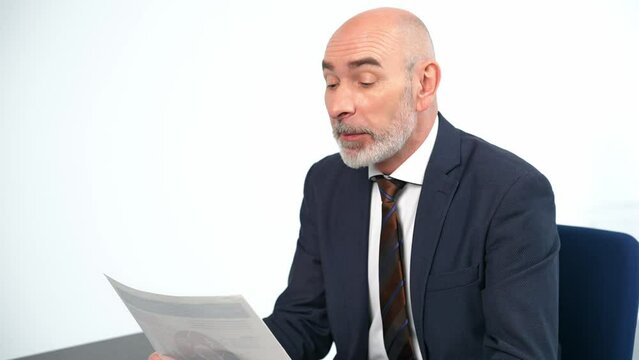 Middle-aged white man in a suit talking in the office. Job interview. Online meeting.