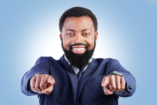 Business, portrait and black man hand pointing in studio for hiring, recruitment or opportunity on blue background. Face, smile and African male person show you, emoji and coming soon or contact us