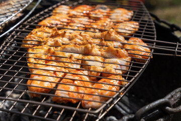 Grill with chicken being grilled