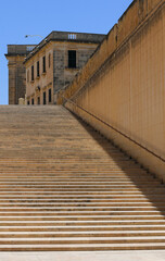 Fototapeta na wymiar Long stairs from yellow stone near to Valletta City Gate in Malta 