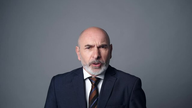 Middle-aged white man in a suit getting angry. Facial expression.