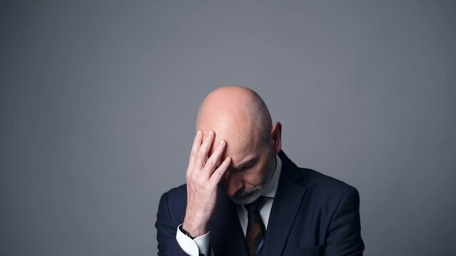 Depressed middle-aged white man in a suit. Facial expression.