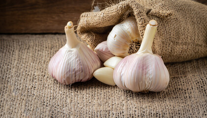 Garlic Over wooden and gunny sack background
