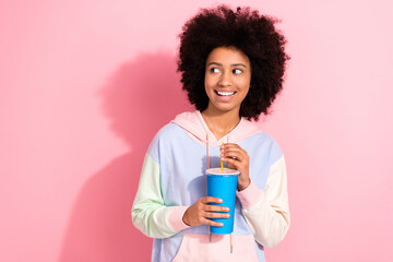 Photo of thoughtful dreamy small kid wear sweatshirt drinking cold beverage looking empty space...