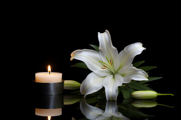 Obraz na płótnie Canvas Beautiful lily and burning candle on dark background. Funeral flower. Generative Ai.