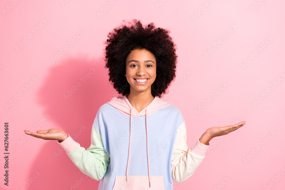 Sticker Photo of shiny cute small kid wear sweatshirt showing arms scales comparing empty space isolated pink color background