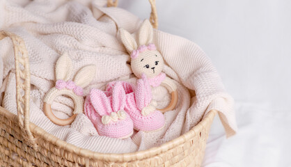 Fototapeta na wymiar Cute wooden and knitted baby toys on light background. Eco accessories and teethers for newborns. 
