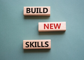 Build New skills symbol. Concept word Build New skills on wooden blocks. Beautiful grey green background. Business and Build New skills concept. Copy space