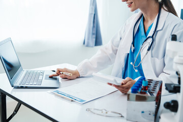 Health care researchers working in life science laboratory, Teaching in labs - Requiring students to record their laboratory methods and results as a running record of their laboratory work.