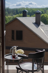 Good morning. Drinking tea on the balcony overlooking nature.