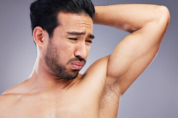 Armpit, smell and man with body odor in studio isolated on a white background for deodorant,...