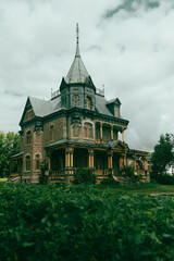 Derelict early 20th Century Victorian mansion seen on Avenue Royale in summer, L’Ange Gardien,...