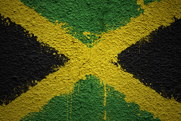 painted big national flag of jamaica on a massive old cracked wall