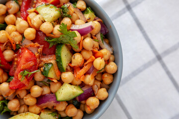 Homemade Avocado Chickpea Salad with Chili Lime Dressing in a Bowl, top view. Space for text.