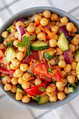 Homemade Avocado Chickpea Salad with Chili Lime Dressing in a Bowl, top view. Close-up.