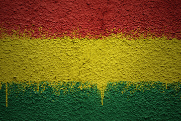painted big national flag of bolivia on a massive old cracked wall