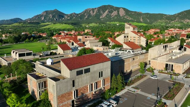 University of Colorado Boulder aerial establishing shot. Beautiful red roofs and mountains in background.