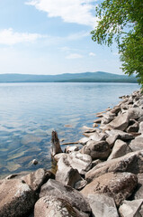 Fototapeta na wymiar Summer view of lake Turgoyak with its rocky shoreline, South Urals, Russian Federation