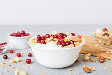 Healthy breakfast food with granola, yogurt, fruits and nuts. Dessert parfait with dried fruits for breakfast