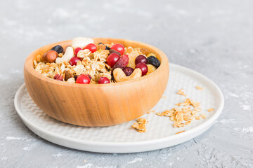 Cooking a wholesome breakfast. Granola with Various dried fruits and nuts in a bowl. The concept of a healthy dessert. Flat lay, top view with copy space