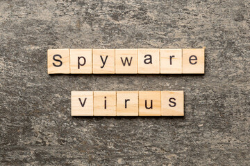 Fototapeta premium Spyware virus word written on wood block. Spyware virus text on cement table for your desing, concept