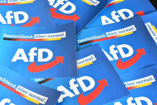 Burgdorf, Lower Saxony, Germany - July 9, 2023: Paper flags with the logo of  the right-wing political party Alternative for Germany, AfD