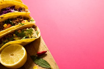 Draagtas High angle view of tacos garnished with lemon slice, red chili and leaf on serving board, copy space © vectorfusionart