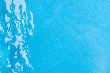 Close up of water ripples and waves with copy space on blue background