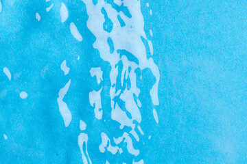 Close up of water ripples and waves with copy space on blue background