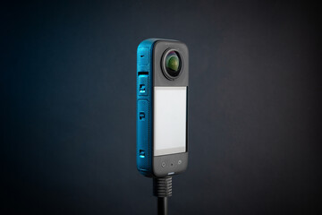 Modern 360 degree digital camera on black background