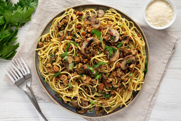 Homemade Mushroom, Spinach & Sausage Spaghetti on a Plate, top view. Overhead, from above, flat lay.