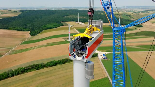 Wind Turbine Head Construction With Huge Crane - aerial drone shot