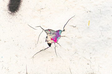 Close up of the colorful cracks and chips of an old wall.