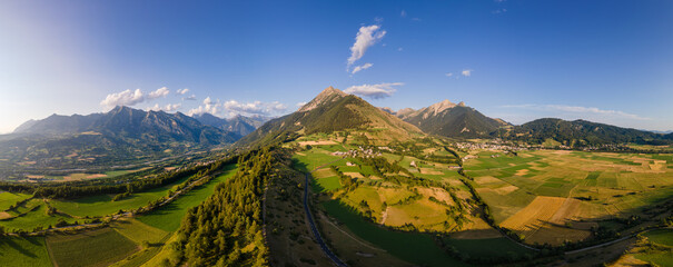 Panoramic aerial view of villages of Les Faix (center), Ancelle (right) and Saint-Leger-les-Melezes (left). Summer in Champsaur Valley, Hautes Alpes (Alps), France